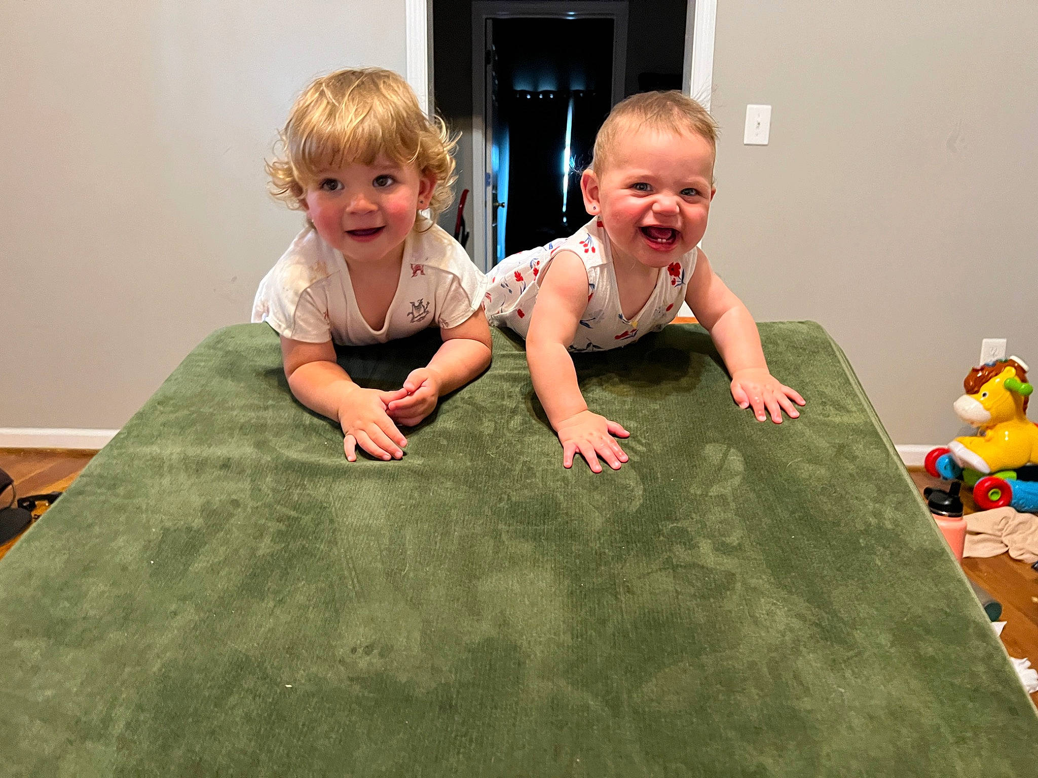 Enola is registered to the contest to win money with this photo: baby, baby_toddler_clothing, child, comfort, crawling, face, facial_expression, floor, flooring, fun, grass, happy, hardwood, head, joy, leisure, people_in_nature, person, sitting, smile