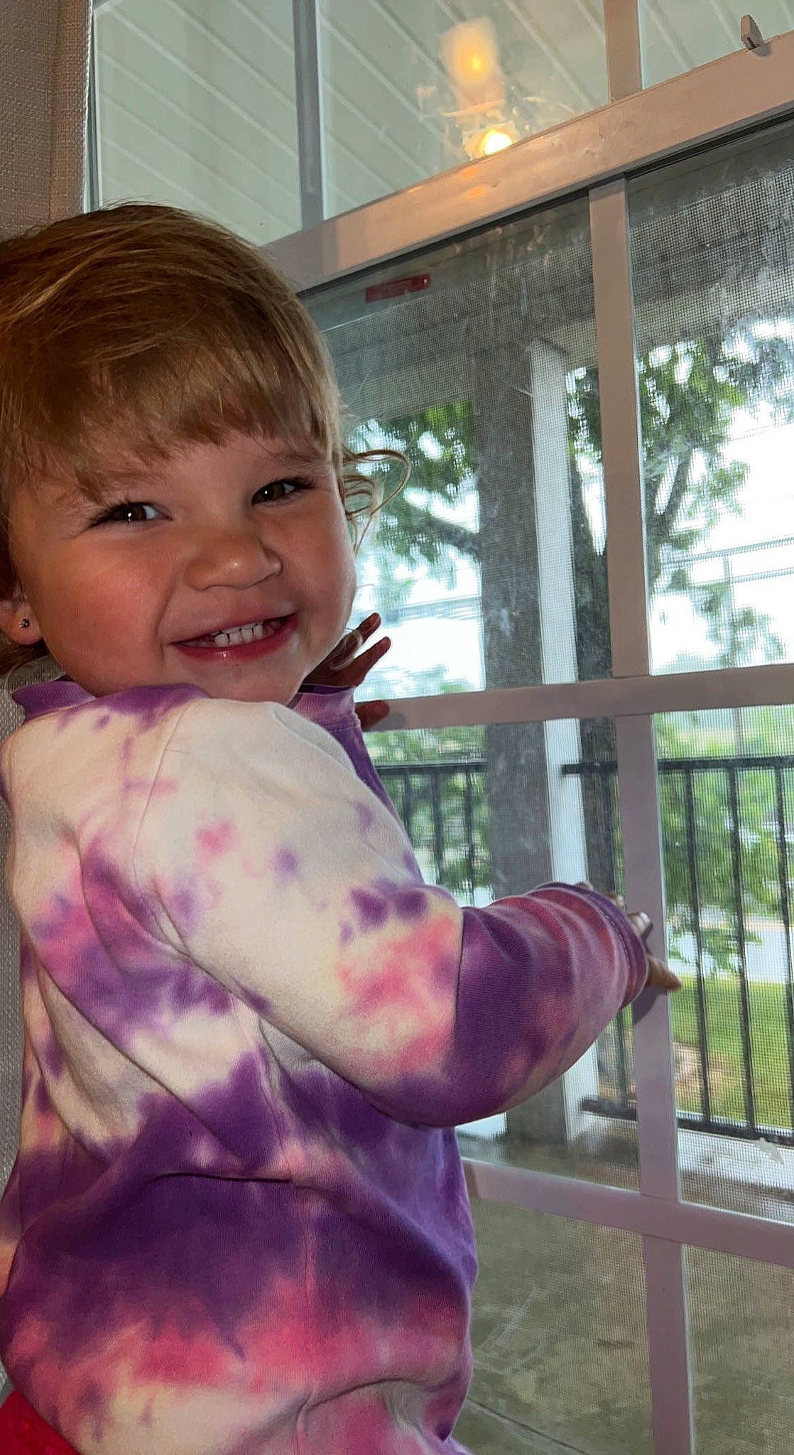 Isla joined the competition — help win amazing prizes! cheek, eye, facial_expression, finger, gesture, grass, happy, human_body, joy, lip, mouth, neck, nose, person, pink, plant, skin, smile, thumb, toddler