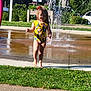 Aurora is registered to the contest to win money with this photo: child, toddler, swimsuit, water, splash_pad, grass, sunlight, outdoor, park, barefoot, running, water_spray, summer, play, fun, nature, daytime, person, happy, active