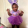 toddler, child, smiling, purple_tutu, bunny_ears, indoor, cute, happy, standing, clothing, shoes, headband, playful, portrait, person, fashion, fun, expressive, young_child, adorable