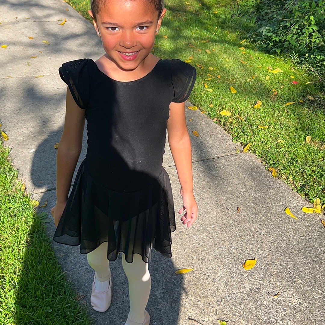 Ellyana is registered to the contest to win money with this photo: child, clothing, dress, face, female, footwear, girl, grass, head, nature, path, person, photography, plant, portrait, shoe, sidewalk, skirt, slate, walkway