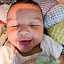 Miles joined the competition — help win amazing prizes! baby, smile, face, infant, blanket, pillow, white_shirt, cozy, happy, lying_down, soft_texture, home, child, cute, closeup, indoor, expression, comfort, adorable, shadow
