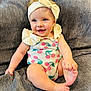 baby, headband, bow, romper, cherry_pattern, smiling, blue_eyes, barefoot, hand, foot, blanket, gray, texture, sitting, cute, child, indoors, happy, person, infant