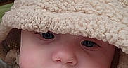 Brixlee is registered to the contest to win money with this photo: baby, child, face, hood, fuzzy_clothing, cute, indoor, portrait, soft_texture, warm, infant, apparel, headwear, expression, closeup, person, cozy, adorable, young, sleepwear
