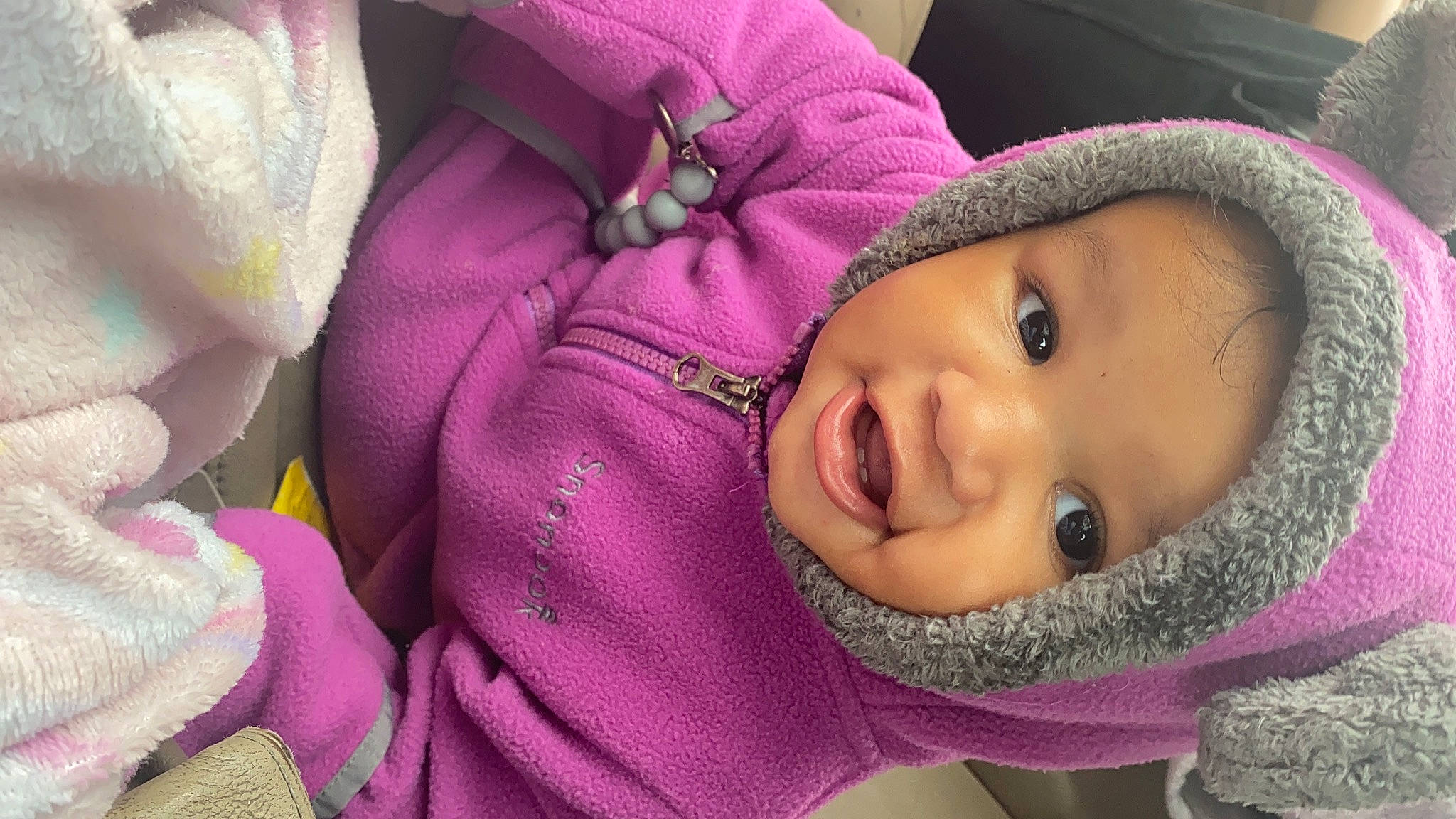 Joni joined the competition — help win amazing prizes! baby, cap, cheek, eye, eyelash, facial_expression, happy, headwear, jacket, lip, nose, outerwear, person, pink, product, purple, skin, smile, textile, toddler