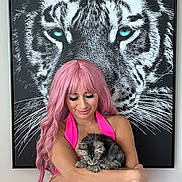 Vader joined the competition — help win amazing prizes! woman, person, cat, kitten, tiger, animal, pink_hair, pink_dress, neon_color, portrait, indoors, wall_art, framed_picture, holding, sleeping, long_hair, makeup, eyelashes, whiskers, pet