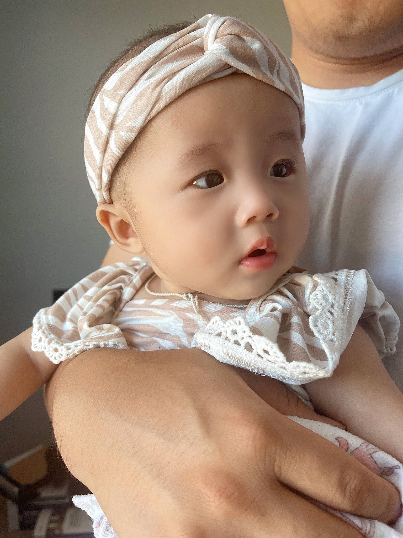Aurora is registered to the contest to win money with this photo: baby, baby_toddler_clothing, cap, cheek, child, collar, dress, eyebrow, eyelash, fashion_accessory, finger, gesture, hair_accessory, happy, headwear, iris, lip, person, skin, sleeve