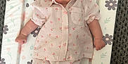Lucia joined the competition — help win amazing prizes! baby, infant, child, lying_down, changing_pad, floral_pattern, pink_clothing, striped_outfit, smiling, cute, small_hands, small_feet, carpet, pastel_colors, soft_texture, portrait, indoors, sleepwear, cozy, comfortable