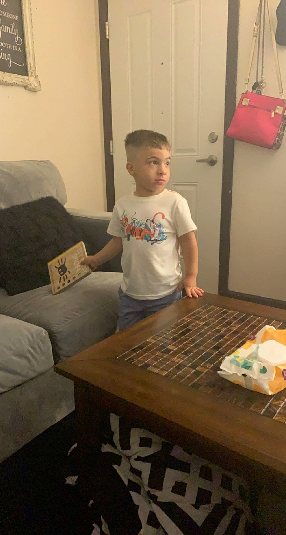 Jamari is registered to the contest to win money with this photo: child, coffee_table, couch, floor, flooring, fun, furniture, hardwood, interior_design, living_room, person, picture_frame, play, room, t_shirt, table, tableware, toddler, varnish, wood