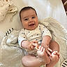 Rose participe au concours pour gagner de l'argent avec cette photo : apparel, baby, bed, blanket, child, clothing, cozy, cute, face, feet, hands, happy, indoor, infant, lying_down, newborn, person, skin, smiling, soft