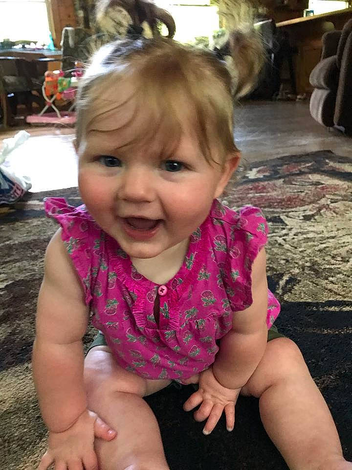 Briar is registered to the contest to win money with this photo: baby, blond, cheek, child, eye, face, facial_expression, finger, fun, head, leg, lip, mouth, neck, nose, person, pink, sitting, skin, smile