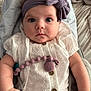 Layla joined the competition — help win amazing prizes! baby, infant, headband, bow, white_clothing, pacifier_clip, buttoned_shirt, cute, wide_eyes, curious, arm, hand, skin, indoors, soft_light, portrait, child, person, closeup, seated