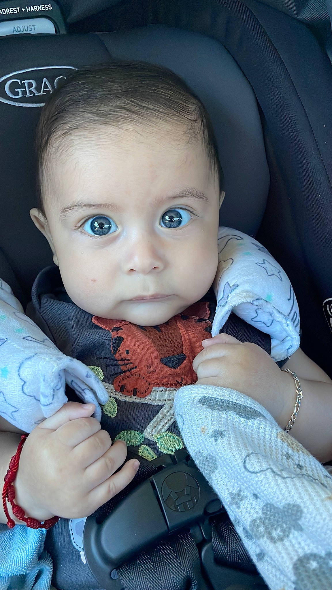 Jose is registered to the contest to win money with this photo: azure, baby, baby_toddler_clothing, blue, car_seat, cheek, chin, comfort, eye, eyebrow, finger, gesture, hand, head, iris, mouth, nail, nose, person, skin