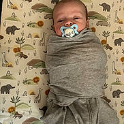 Cashton joined the competition — help win amazing prizes! baby, pacifier, swaddle, blanket, infant, animal_print, giraffe, lion, elephant, hippo, pattern, sleeping_area, cute, child, toddler, lying_down, gray_clothing, nursery, soft, calm