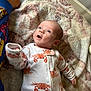 baby, infant, onesie, crab_pattern, blanket, blue_eyes, hand, foot, pajamas, sleepwear, lying_down, indoor, child, cute, expression, soft_texture, cozy, person, face, apparel