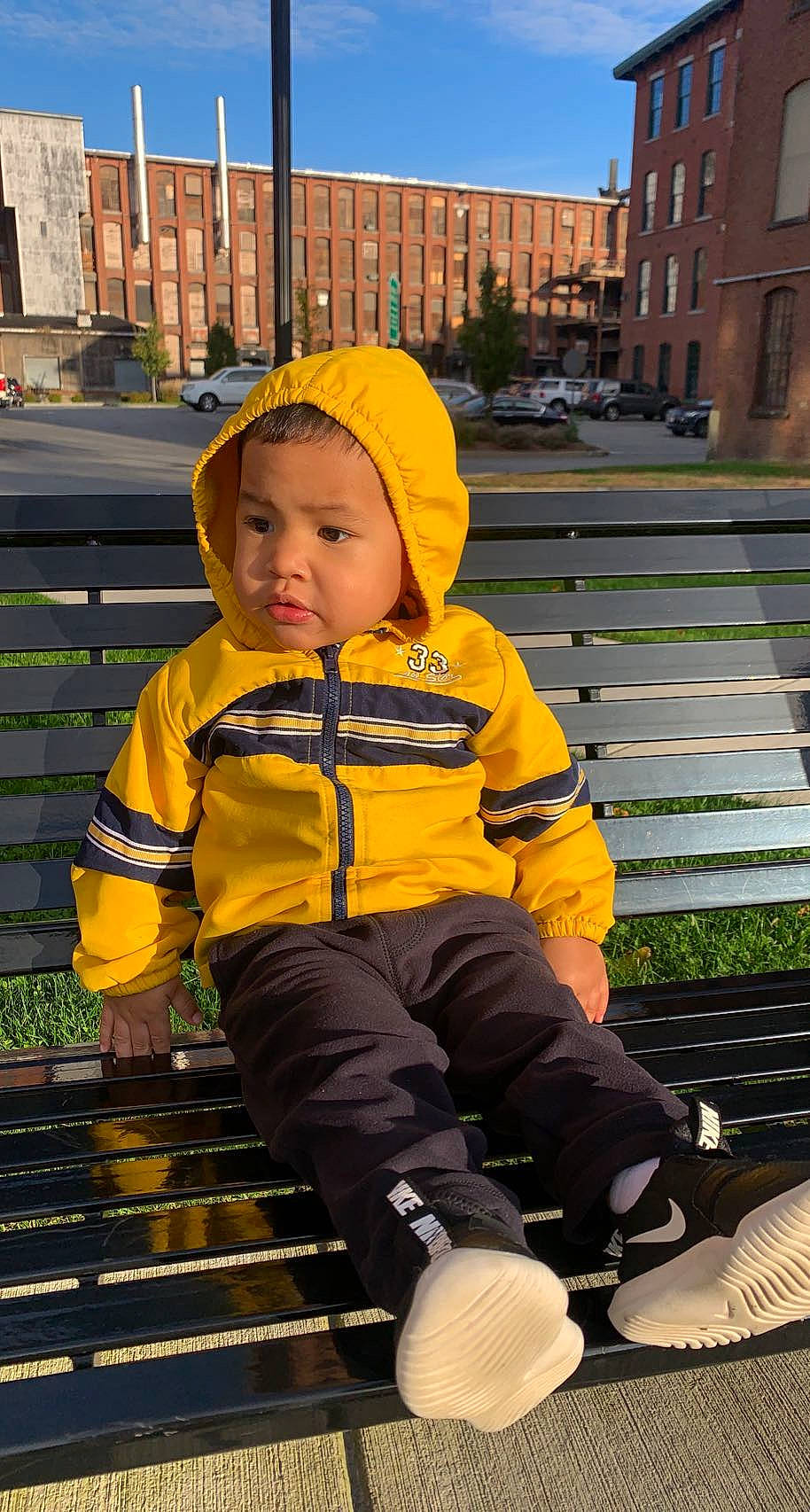 Khamari joined the competition — help win amazing prizes! baby_toddler_clothing, blue, building, cap, child, city, fun, grass, hoodie, leisure, person, plant, recreation, sitting, sky, standing, toddler, travel, window, winter