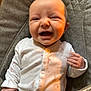 baby, baby_seat, child, clothing, cushion, cute, expression, fist, gray_fabric, happy, human, indoor, infant, onesie, pink_pattern, portrait, seat, smile, white_clothing, young