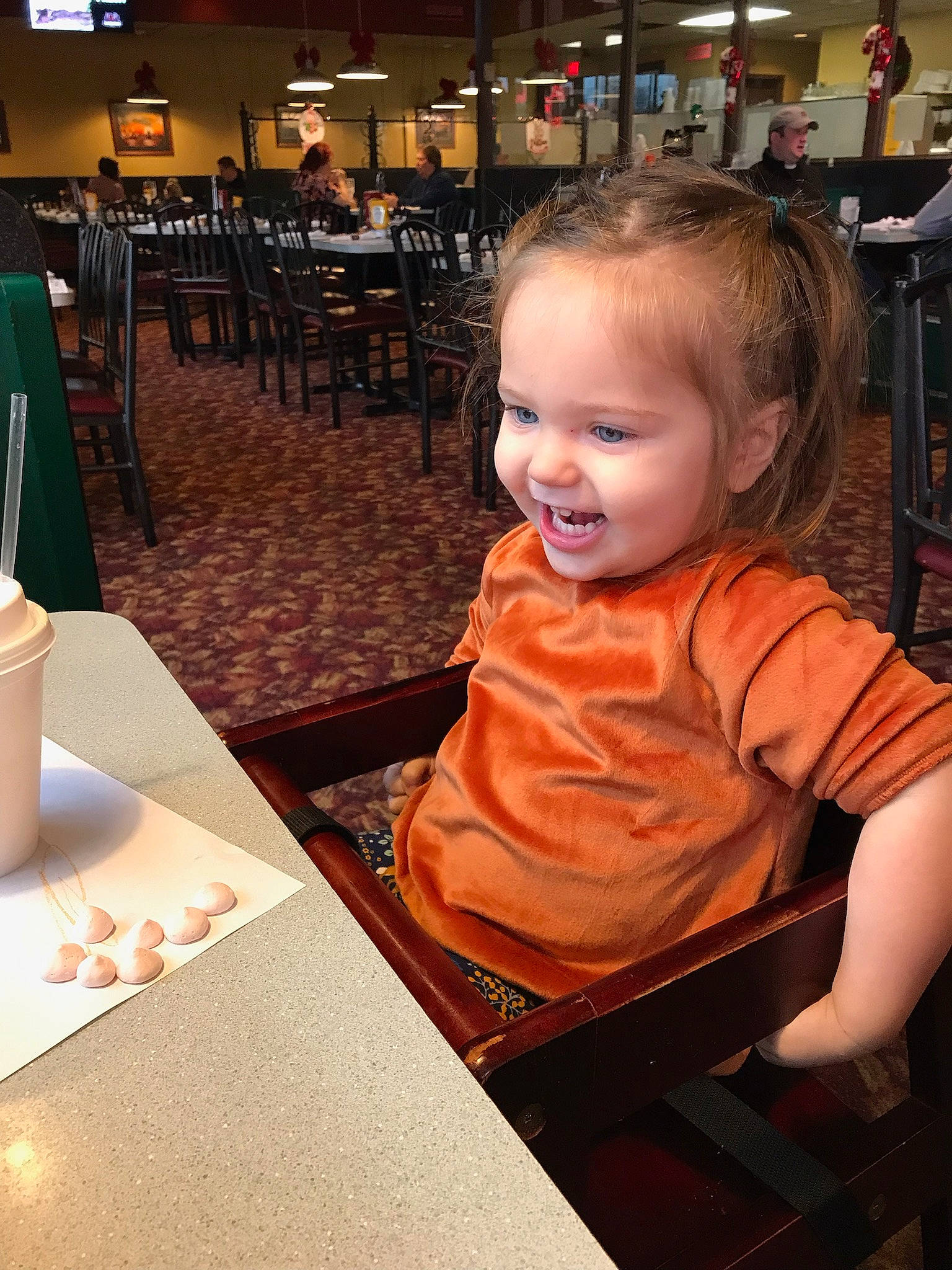 Sloane is registered to the contest to win money with this photo: baby, baby_toddler_clothing, chair, child, drinkware, event, fashion, flooring, fun, hairstyle, happy, head, joy, leisure, person, room, sitting, smile, table, tableware