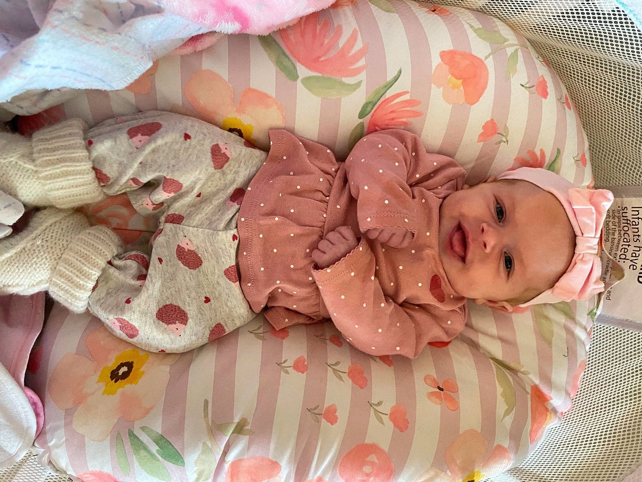Harper joined the competition — help win amazing prizes! baby, baby_products, baby_sleeping, baby_toddler_clothing, bed_sheet, carmine, child, comfort, fashion_accessory, headgear, linens, pattern, peach, person, petal, pink, room, smile, sweetness, toddler