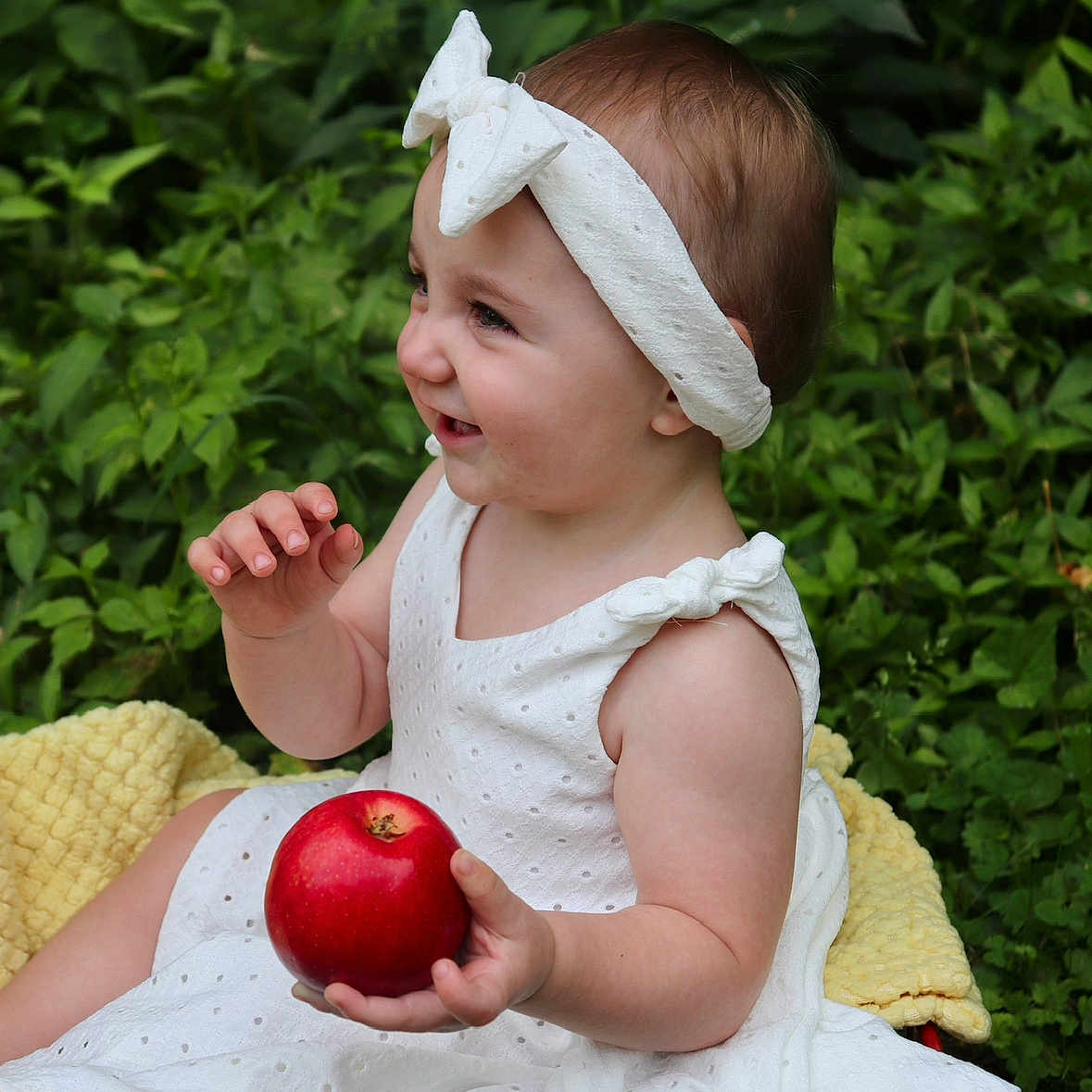 Octavia joined the competition — help win amazing prizes! apple, baby, bodypart, bonnet, clothing, dress, eating, face, finger, flower, food, fruit, hand, head, person, petal, photography, plant, portrait, produce