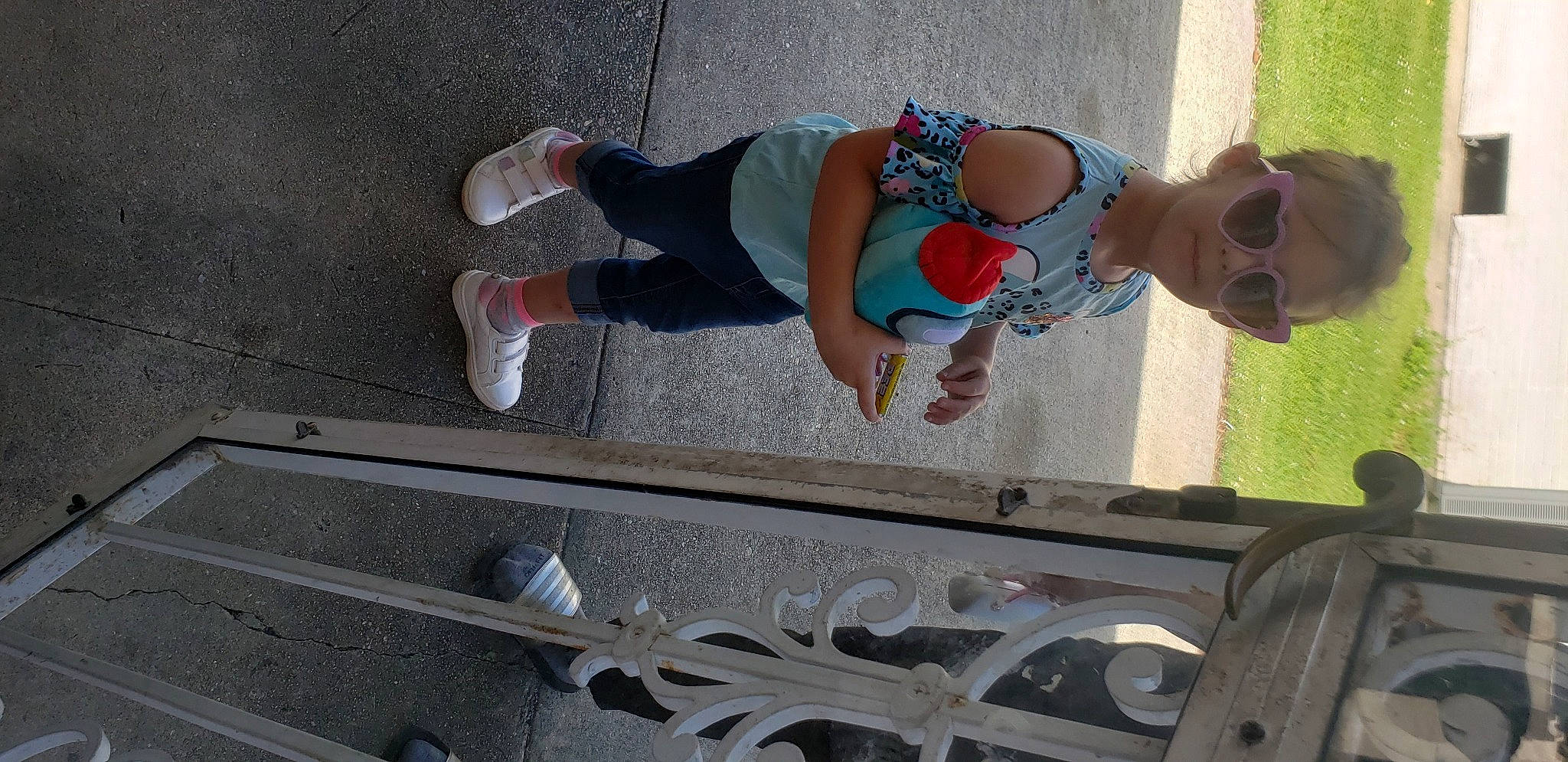Alayna is registered to the contest to win money with this photo: automotive_exterior, baby, child, foot, fun, human_leg, leg, leisure, line, person, recreation, shoe, snapshot, sneakers, sunglasses, thigh, toddler, toy, walking_shoe, white
