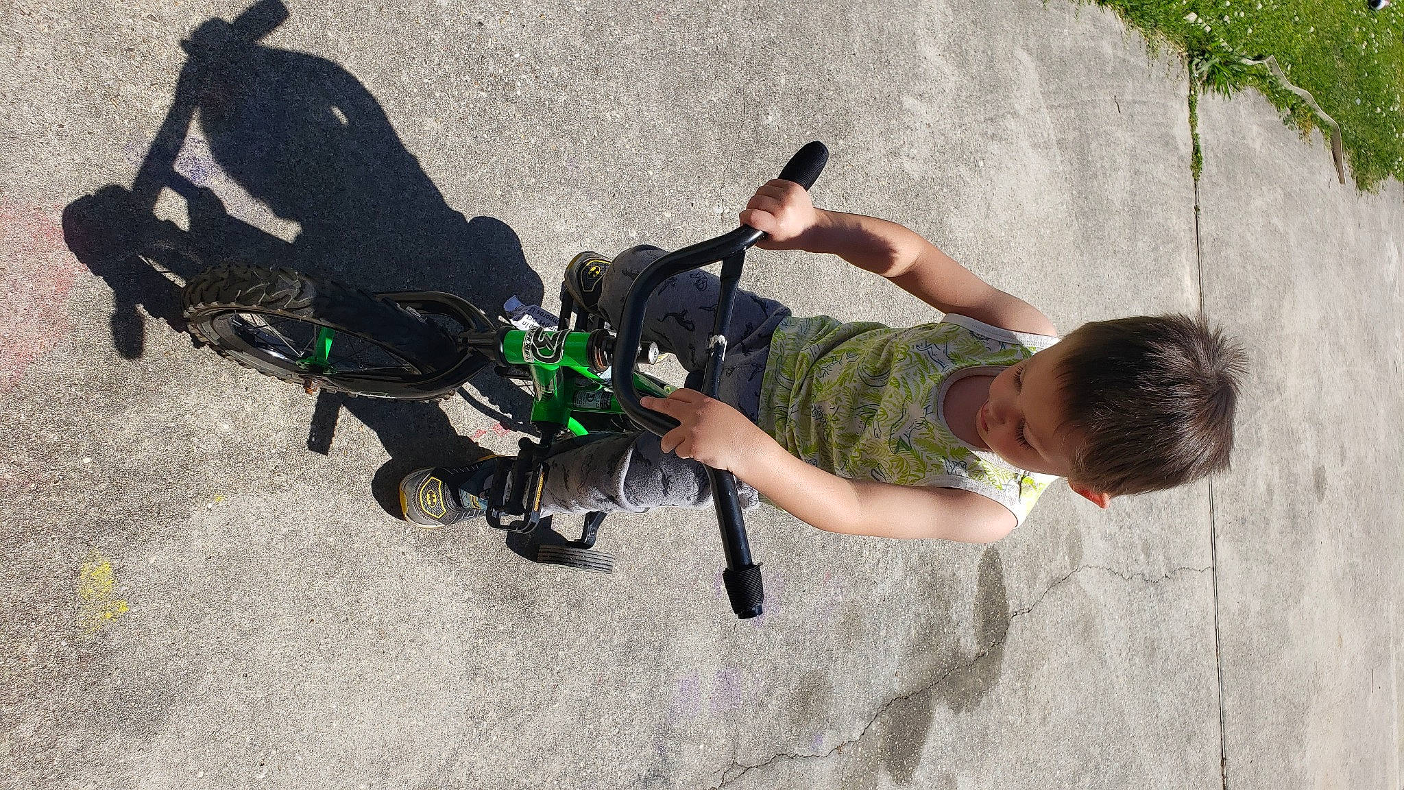 Keith is registered to the contest to win money with this photo: adventure, asphalt, auto_part, bicycle_handlebar, camera, cameras_optics, cycling, extreme_sport, fun, leisure, person, personal_protective_equipment, recreation, shadow, shorts, toddler, vehicle