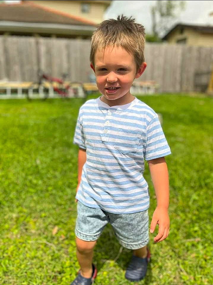 Keith is registered to the contest to win money with this photo: child, fun, grass, grassland, happy, lawn, leisure, pattern, people_in_nature, person, plant, play, recreation, sandal, shorts, sitting, sleeve, smile, spring, t_shirt