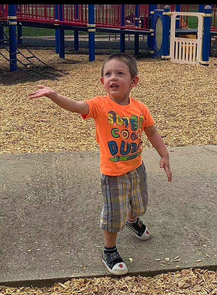 Keith is registered to the contest to win money with this photo: child, city, cool, fun, happy, leisure, metal, pattern, person, play, recreation, shorts, sleeve, standing, street_fashion, t_shirt, toddler, top, tree, vacation