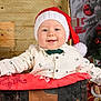 baby, celebration, child, christmas, clothing, cute, decoration, festive, gift, happy, holiday, indoors, portrait, present, red, santa_hat, smile, toy, tree, white