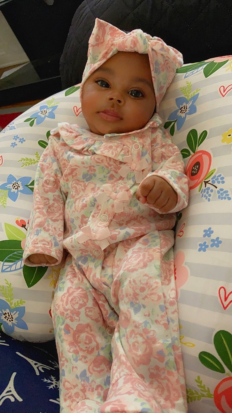 Treasure is registered to the contest to win money with this photo: baby, baby_safety, baby_toddler_clothing, cheek, child, eye, face, facial_expression, green, head, headwear, linens, outerwear, person, pink, product, skin, sleeve, smile, textile