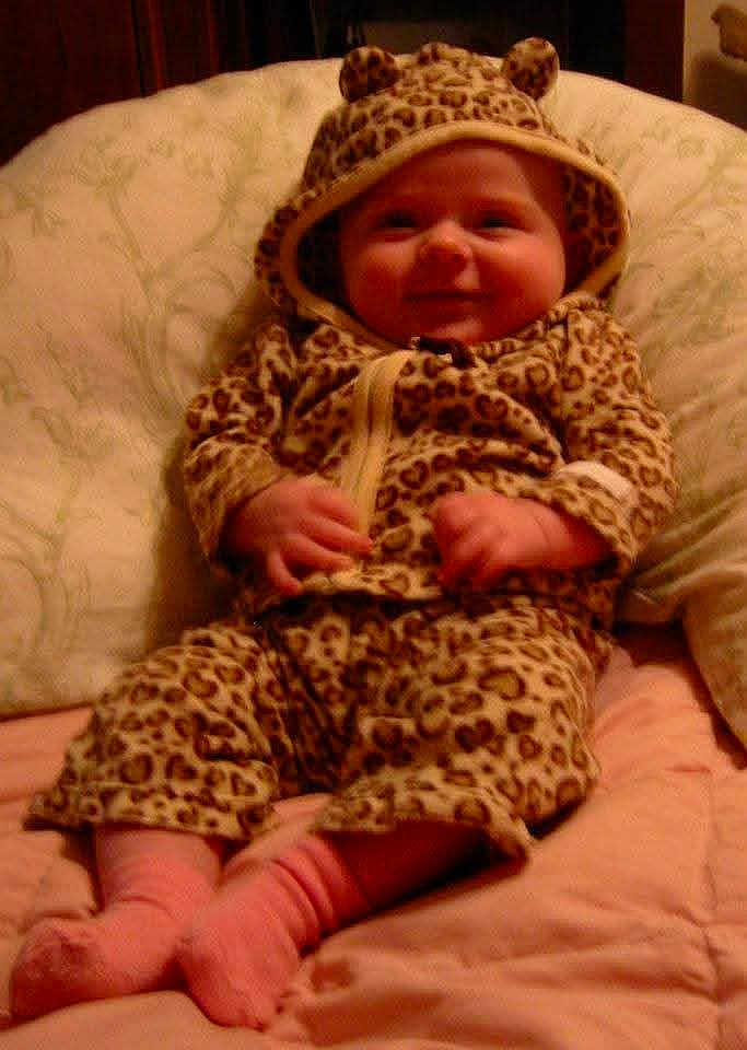 Aydin joined the competition — help win amazing prizes! baby, infant, leopard_print, hooded_suit, pink_socks, smiling, cute, chubby_cheeks, cushion, blanket, indoors, child, portrait, baby_clothes, cozy, comfortable, happy, sitting, pajamas, soft