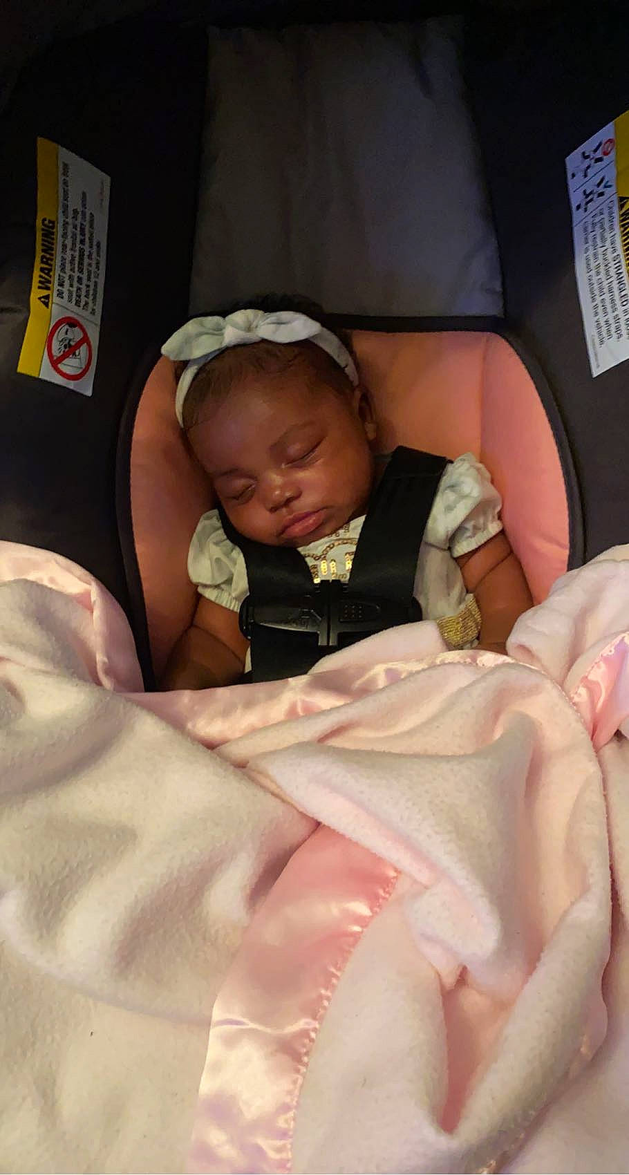 Halo is registered to the contest to win money with this photo: baby, baby_in_car_seat, baby_products, baby_safety, baby_sleeping, baby_toddler_clothing, bedtime, cheek, child, comfort, finger, hand, linens, mouth, person, pink, room, skin, textile, thumb