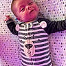 arm, baby, blanket, cozy, crib_sheet, cute, eyes, face, hand, infant, lying_down, newborn, nursery, onesie, patterned_blanket, portrait, purple_lighting, smile, striped_onesie, stripes