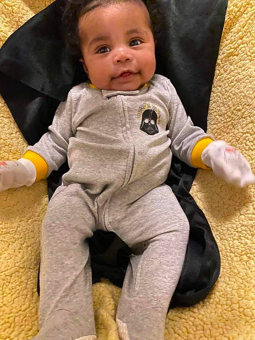 Koda joined the competition — help win amazing prizes! baby, baby_products, baby_toddler_clothing, barefoot, cheek, child, comfort, finger, flooring, foot, happy, human_leg, knee, linens, outerwear, person, sitting, skin, sleeve, smile