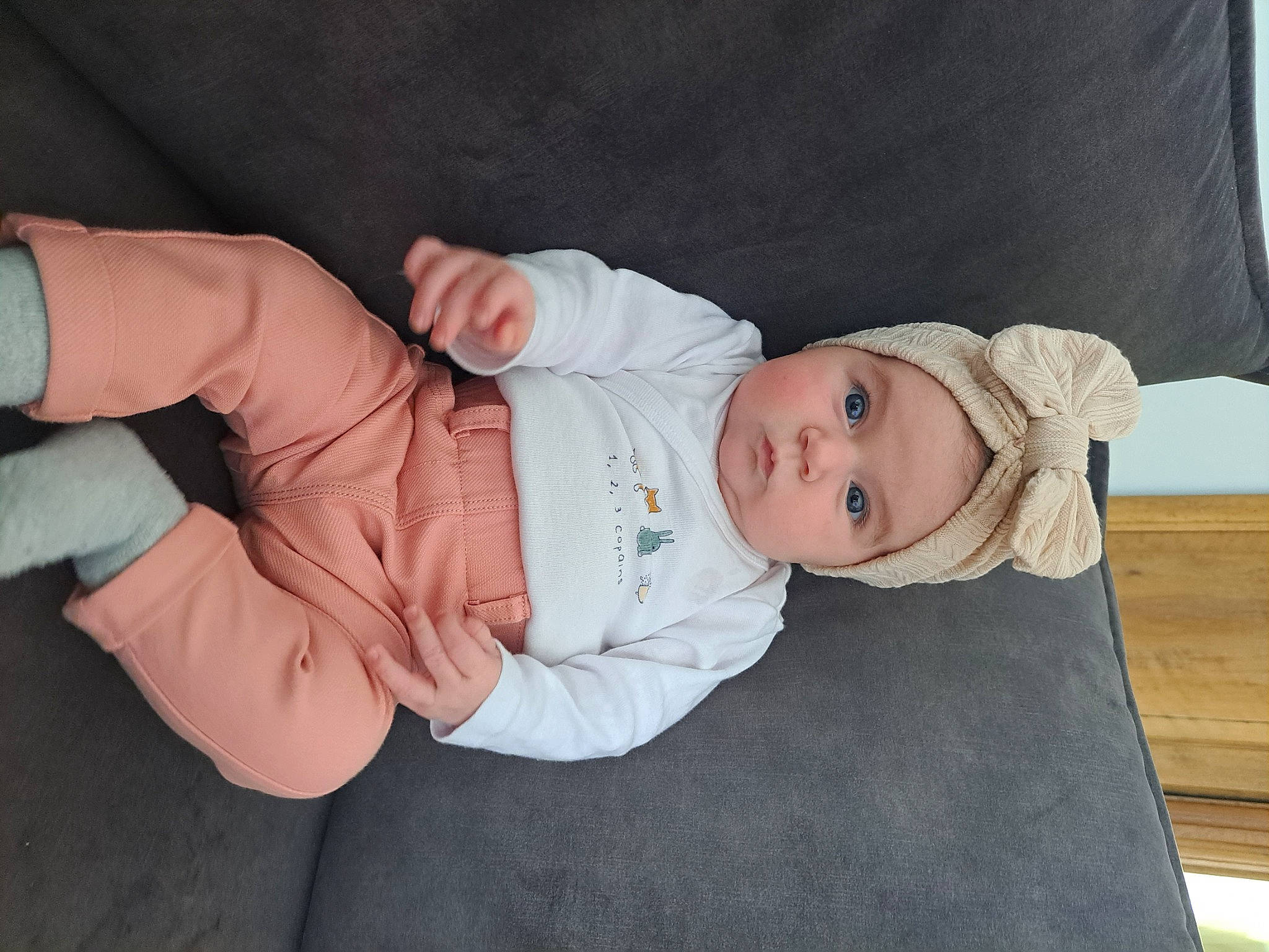 Alix participe au concours pour gagner de l'argent avec cette photo : baby, baby_products, baby_toddler_clothing, child, comfort, dress, foot, gesture, hand, headwear, linens, nail, person, sitting, skin, sleeve, thumb, toddler, wood, wrist