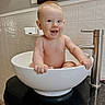 baby, sink, bathroom, smiling, child, tile_wall, faucet, mirror, happy, bare_chest, cute, infant, playful, water, countertop, portrait, indoor, holding, sitting, skin