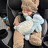 baby, child, car_seat, fuzzy_clothing, hat, pacifier, plush_toy, sleeping, cute, infant, toddler, car_interior, seatbelt, soft_toy, cozy, resting, adorable, childrens_clothing, transportation, nap