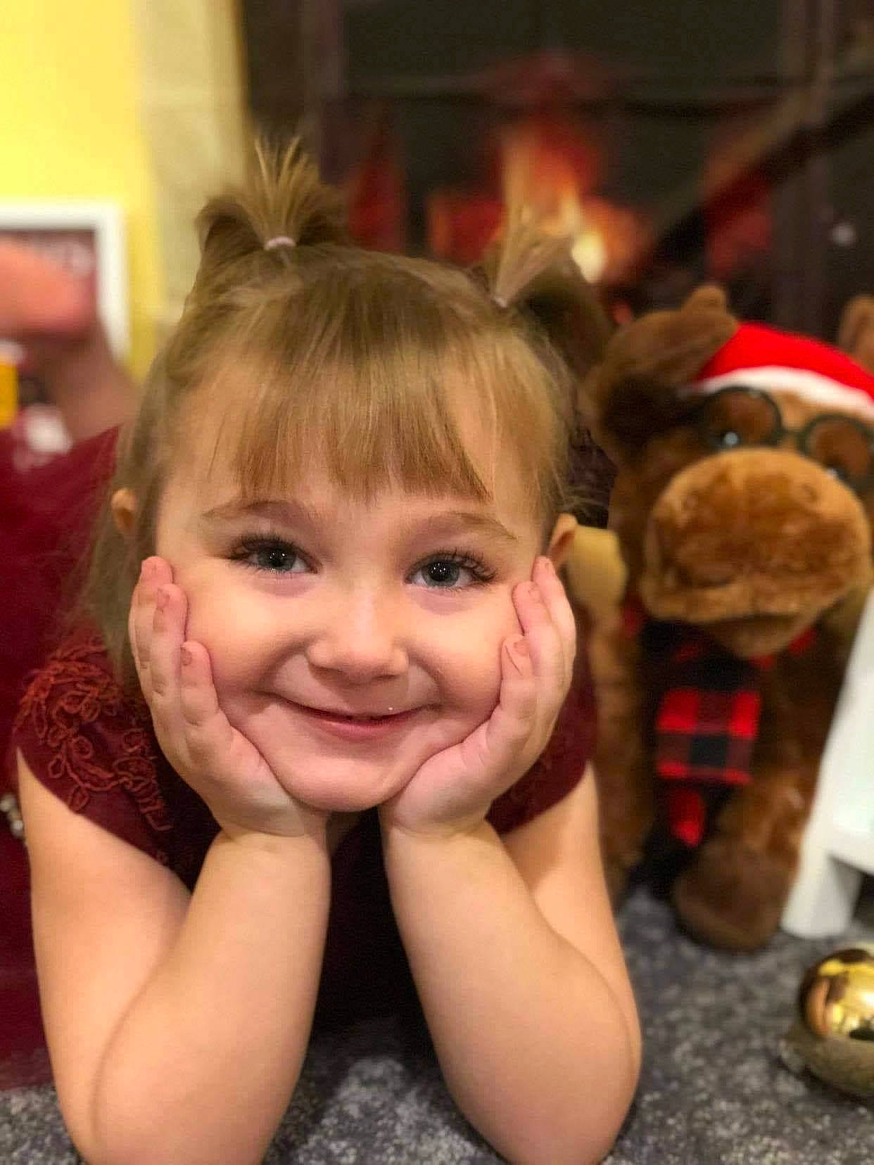 Alyvia is registered to the contest to win money with this photo: brown_hair, cheek, child, event, flooring, fun, fur, gesture, happy, holiday, human_body, joy, laugh, leisure, person, play, room, sitting, smile, thumb