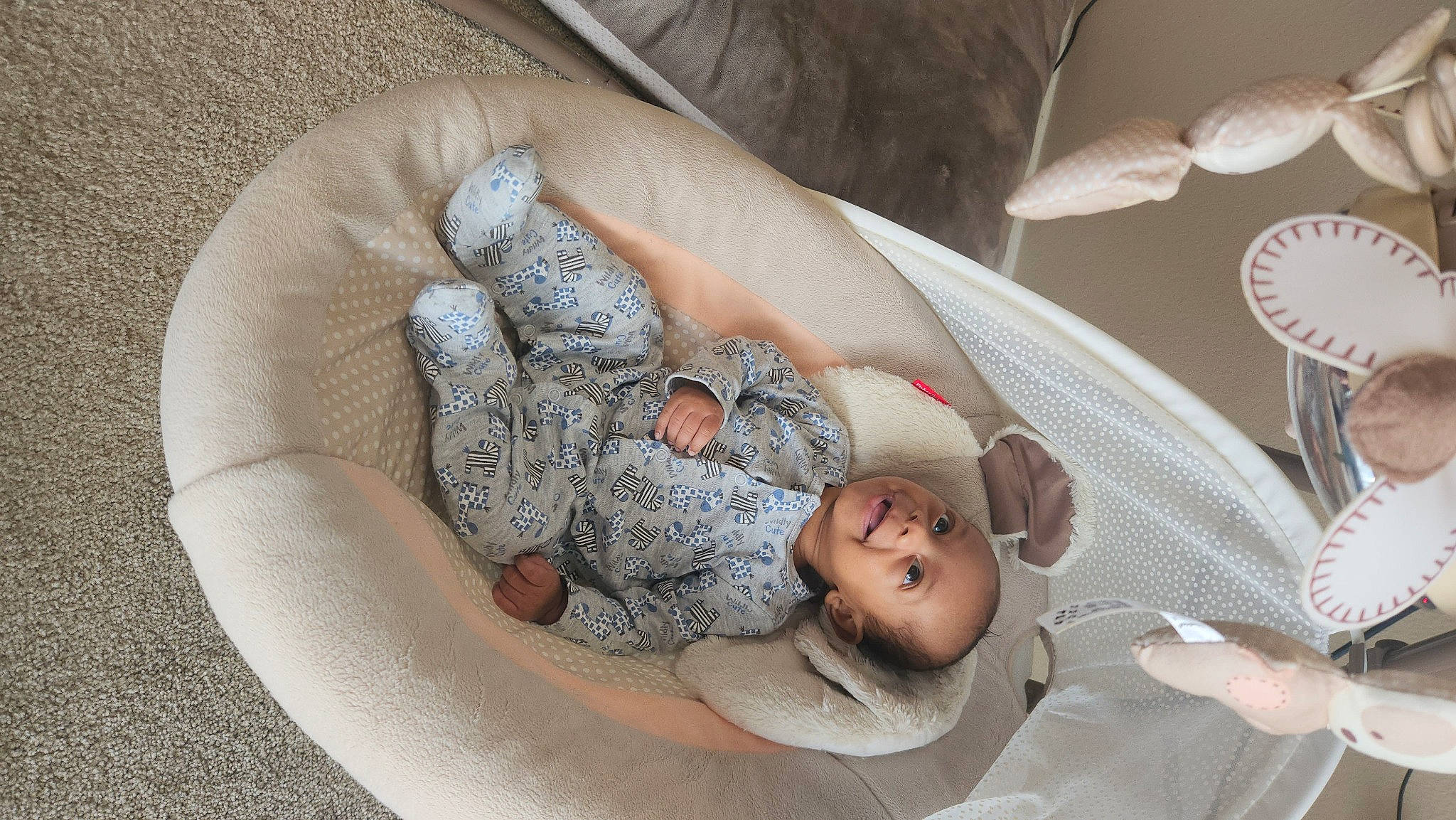 Uriah is registered to the contest to win money with this photo: baby, baby_products, child, circle, comfort, fashion_accessory, flesh, foot, hand, head, human_body, human_leg, leg, linens, pattern, person, room, sitting, sleep, toddler