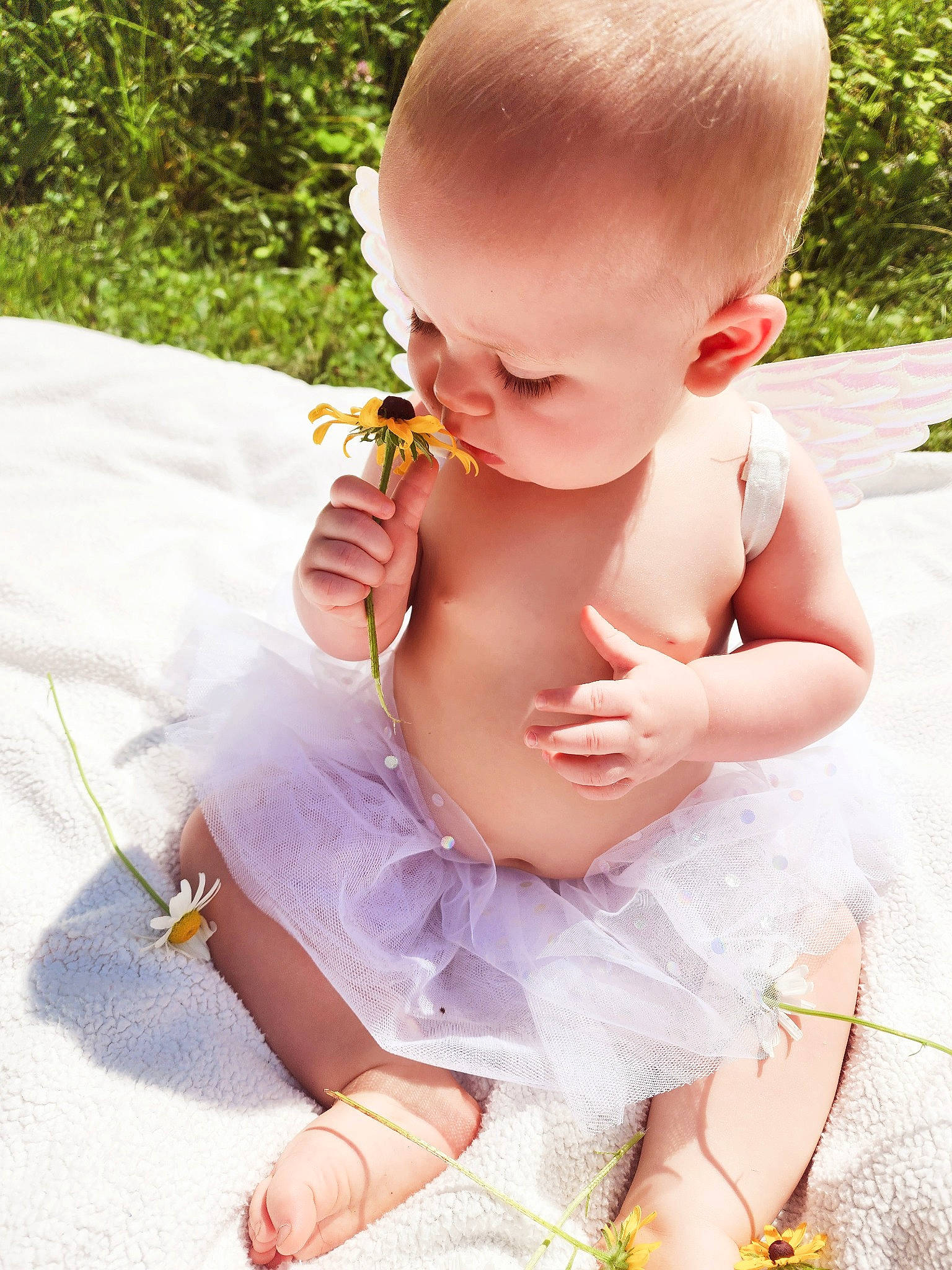Liberty is registered to the contest to win money with this photo: baby, baby_products, baby_toddler_clothing, cheek, child, dress, fun, grass, happy, head, jewellery, nail, person, petal, pink, plant, play, sitting, skin, thumb