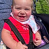 Alona joined the competition — help win amazing prizes! baby, child, smiling, laughing, portrait, stroller, outdoor, sunlight, grass, red_clothing, bib, harness, safety_straps, blonde_hair, blue_eyes, infant, sitting, happy, close_up, photography