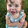 baby, child, infant, smiling, happy, portrait, outdoor, grass, sitting, blue_eyes, curly_hair, light_hair, romper, floral_clothing, bare_arms, bare_legs, hands, close_up, facial_expression, garden