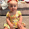 Alona joined the competition — help win amazing prizes! baby, child, toddler, portrait, sitting, smiling, facial_expression, red_headband, bow, colorful_dress, heart_pattern, carpet, living_room, sofa, cushions, blanket, clothing, indoor, happy, photography