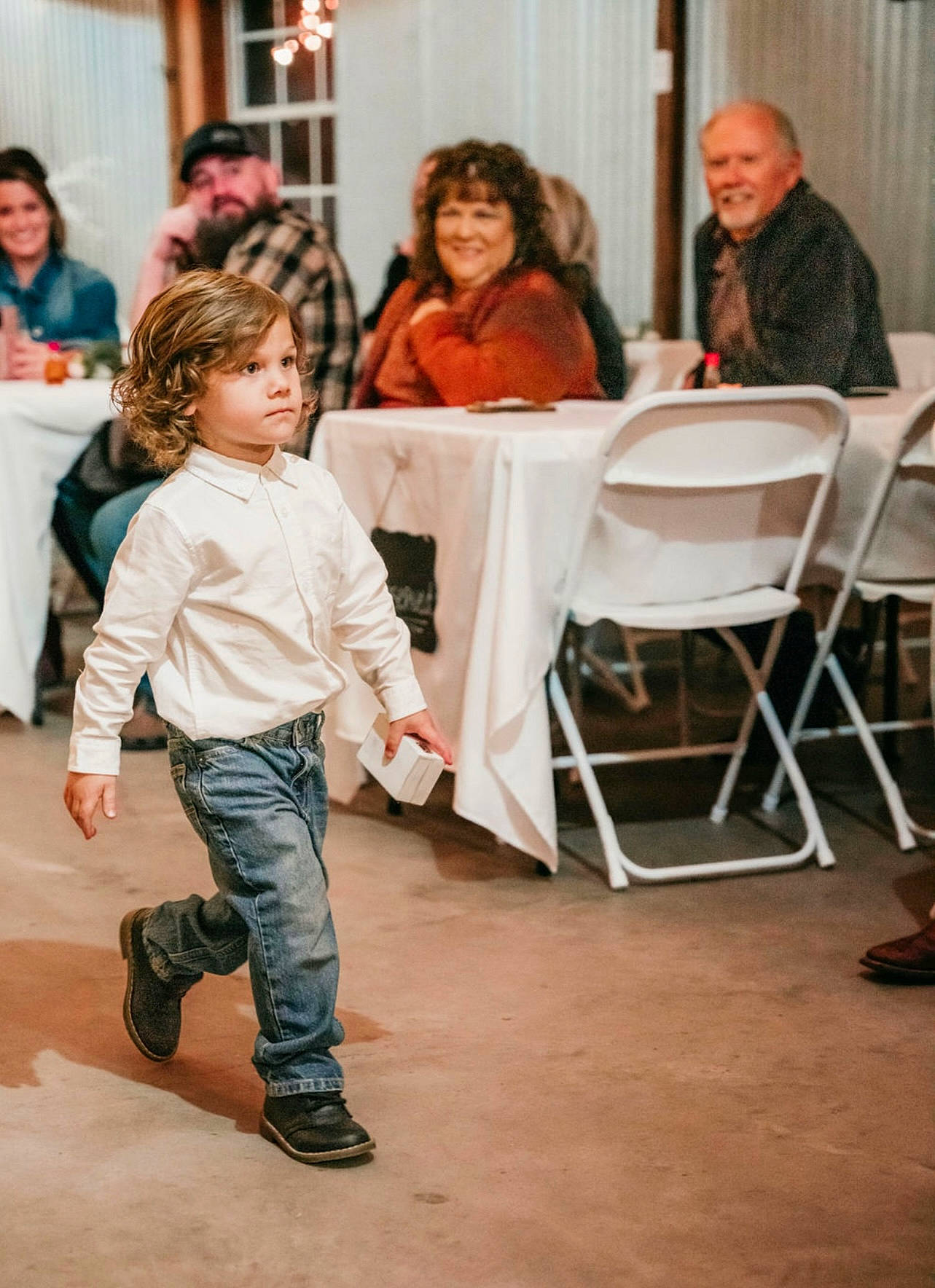 Luke is registered to the contest to win money with this photo: blurred, chair, child, conversation, curtain, entertainment, event, face, fashion_design, flooring, fun, happy, head, headwear, joy, performing_arts, person, room, shoe, sitting