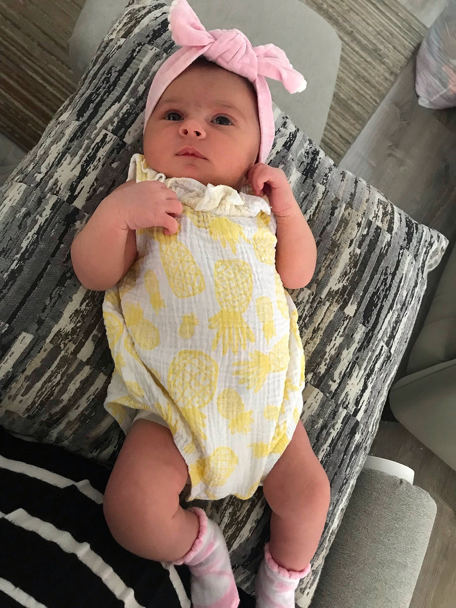 Alaia is registered to the contest to win money with this photo: arm, baby, baby_toddler_clothing, clothing, dress, eye, finger, happy, headwear, human_body, iris, knee, lip, neck, person, pink, skin, sleeve, textile, thigh