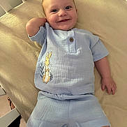 Alfie joined the competition — help win amazing prizes! baby, child, crib, smiling, blue_outfit, rabbit_illustration, infant, happy, cute, lying_down, clothing, shorts, top, skin, furniture, bed, indoors, person, portrait, comfort
