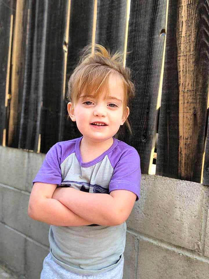 Chloe is registered to the contest to win money with this photo: baby_toddler_clothing, cheek, cool, door, electric_blue, face, fun, happy, iris, joy, leisure, magenta, nose, person, sleeve, smile, standing, t_shirt, thumb, toddler