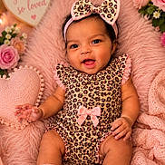 Gianna joined the competition — help win amazing prizes! baby, child, infant, portrait, smiling, sitting, bow, headband, leopard_print, outfit, pink, blanket, fluffy, flowers, roses, heart, decor, cozy, indoor, photography