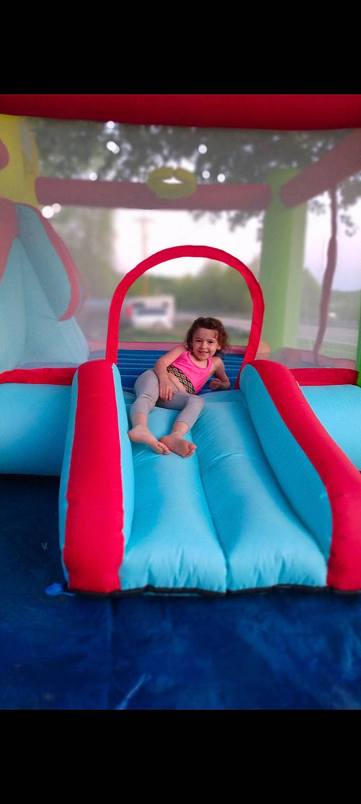 Nevaeh is registered to the contest to win money with this photo: beauty, child, chute, city, comfort, electric_blue, fun, games, inflatable, joy, leisure, magenta, outdoor_play_equipment, person, pink, play, playground, recreation, sitting, smile