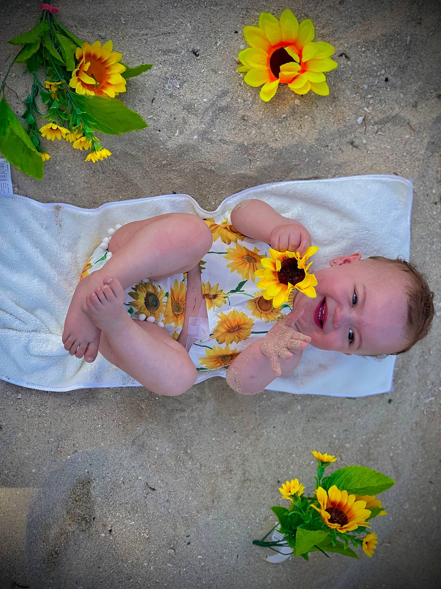 Amalia is registered to the contest to win money with this photo: baby, baby_toddler_clothing, child, cut_flowers, flooring, flower, grass, hand, happy, human_leg, joy, leaf, orange, pattern, people_in_nature, person, petal, plant, sitting, spring